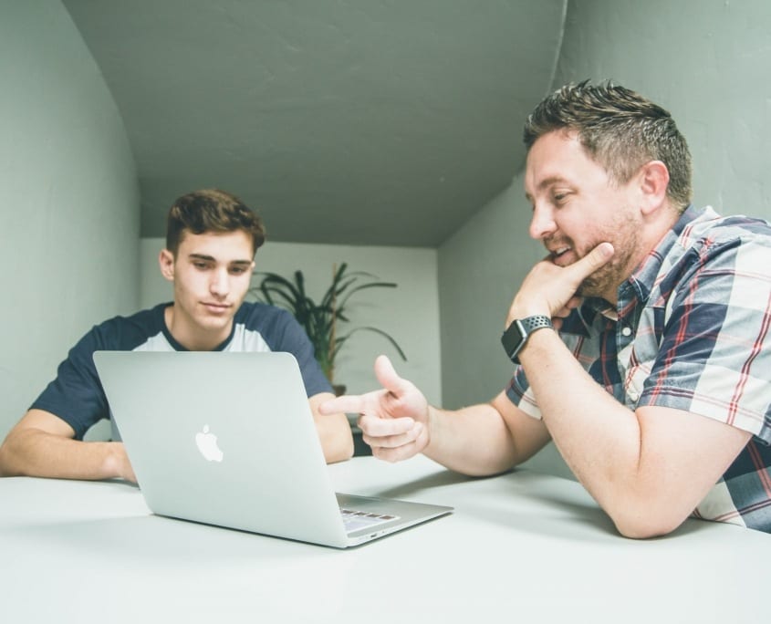 Two men looking at laptop